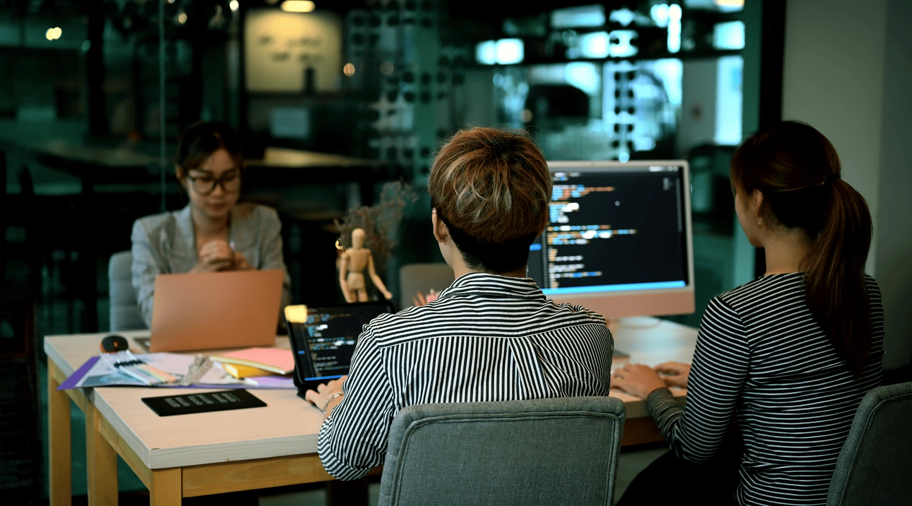 Two programmers looking at their screens